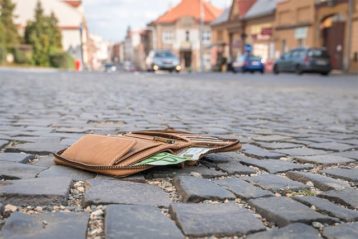 An image featuring a lost wallet on the street concept