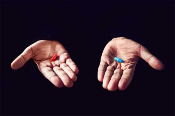 An image featuring two hands with blue and red pill representing matrix movie concept
