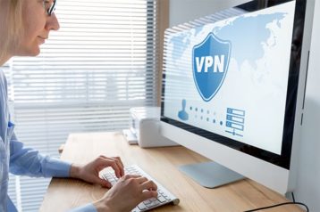 An image featuring a person using his Mac with a VPN connection concept