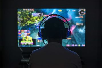 An image featuring a person playing online games and wearing headset concept