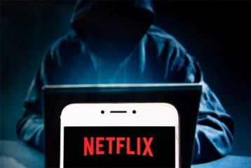 An image featuring a hacker and Netflix opened on phone concept
