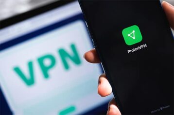 An image featuring ProtonVPN on mobile phone with VPN connection as well in the background on a laptop concept