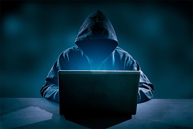 An image featuring a hacker using his laptop to hack concept