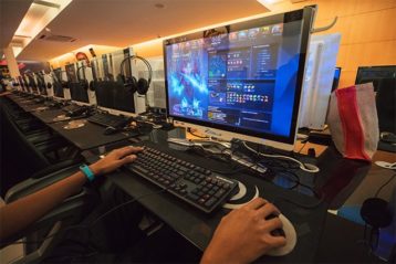 An image featuring a person gaming on PC in a gaming room concept