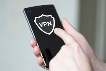 An image of a person using his phone and connecting to a VPN service