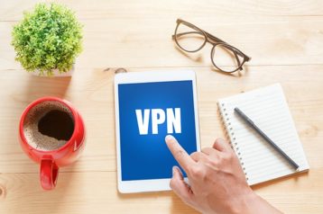 An image featuring a person using his tablet that says VPN on it representing an VPN concept