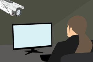person facing tv is being spied on with camera