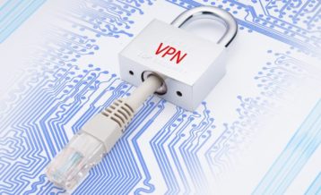 a white keychain with the word vpn on it in red, an ethernet cable is inserted inside of it