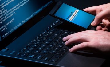 a person succesfully hacking a phone through a laptop