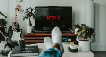 an image of a person sitting in his living room watching netflix on a tv