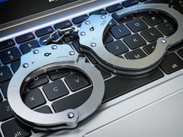 An image featuring a keyboard with handcuffs on top of it representing piracy lawsuit