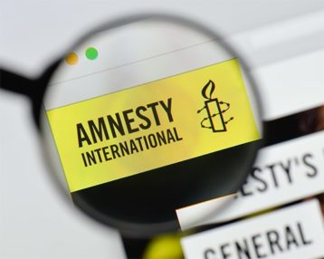 An image featuring the Amnesty International logo and text zoomed in