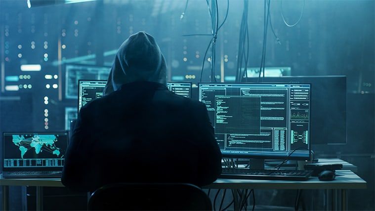An image featuring surveillance data leak concept with a person wearing a hoodie and representing a hacker and is using his pc