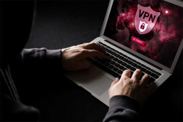 An image featuring a person using their laptop with a VPN service