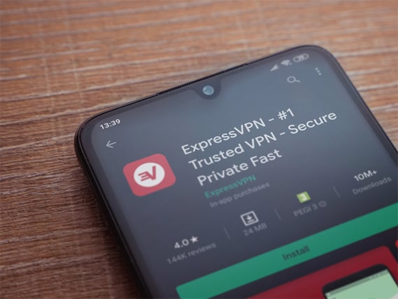An image featuring a phone that has ExpressVPN app searched concept