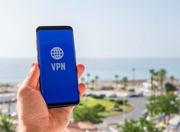 An image featuring a person holding his phone while using a VPN connection concept