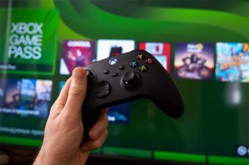 An image featuring a person holding an Xbox controller and is playing online games concept