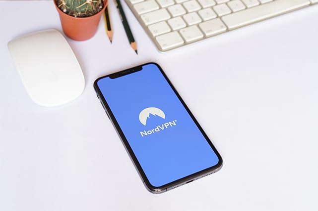 An image featuring a phone that has NordVPN opened on it