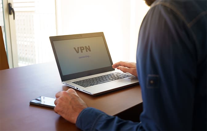 An image featuring a person using a VPN connection on his laptop concept