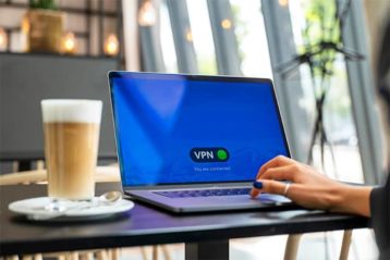 An image featuring a person using a VPN on their laptop while drinking coffee concept