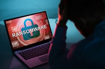 an image with person looking on his laptop with Ransomware 