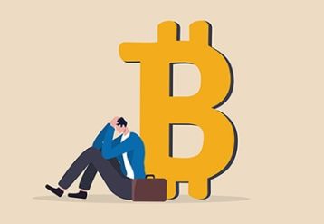 an image with confused businessman sitting next to bitcoin symbol 