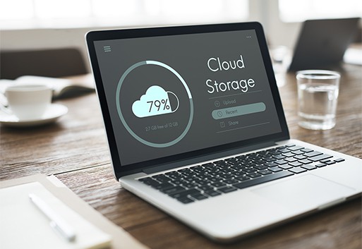 an image with cloud storage uploading on laptop 
