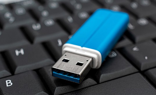 an image with USB flash drive on keyboard