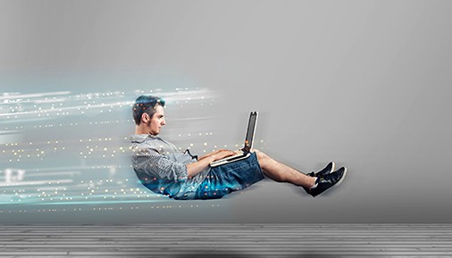 an image with man surfing on his laptop and levitating 