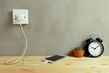 an image with phone charging on portable wall charger 