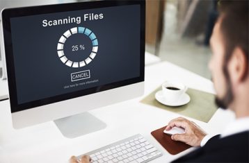 an image with person scanning his Mac