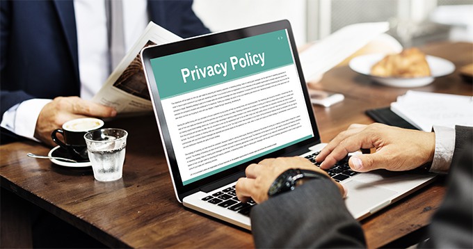 an image with person reading privacy policy on his laptop