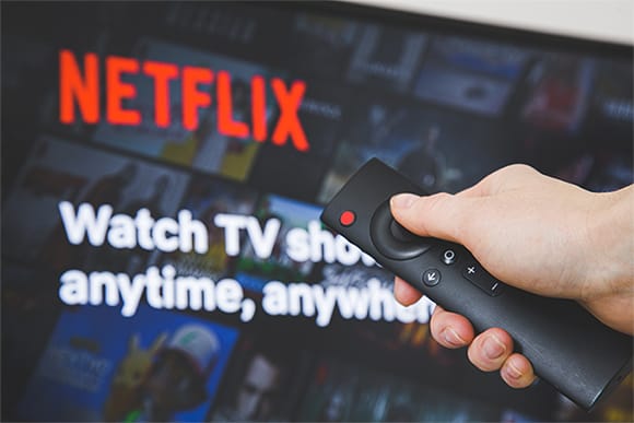 An image featuring a person watching Netflix on his TV concept
