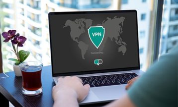 an image with a man uses VPN app on laptop 