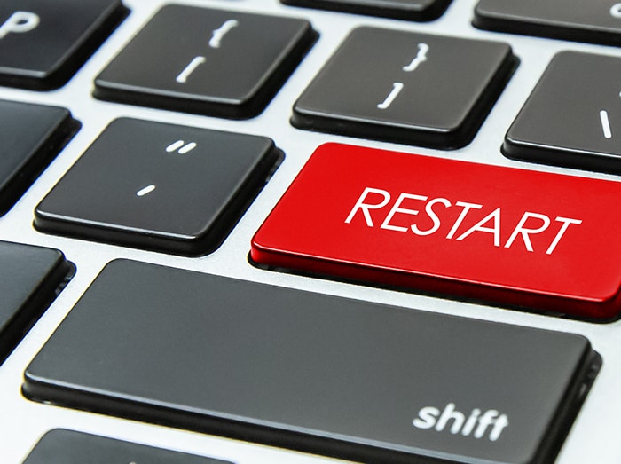an image with restart red button on laptop keyboard 