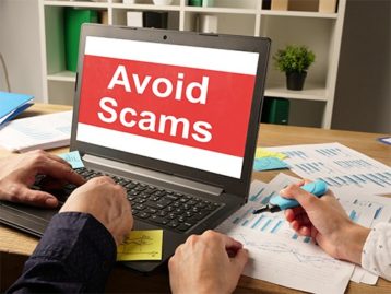 an image with laptop opened on Avoid Scams 
