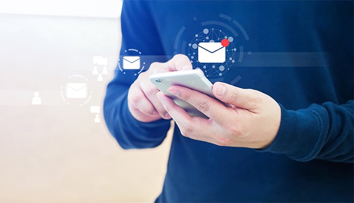 an image with a person holding a smartphone and receiving e mail 