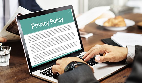an image with businessman reading privacy policy on his laptop