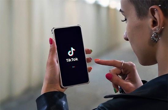 an image with woman opening her TikTok app