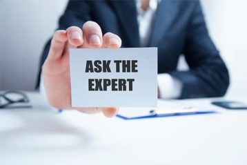 an image with businessman holding a card that says ask the expert 